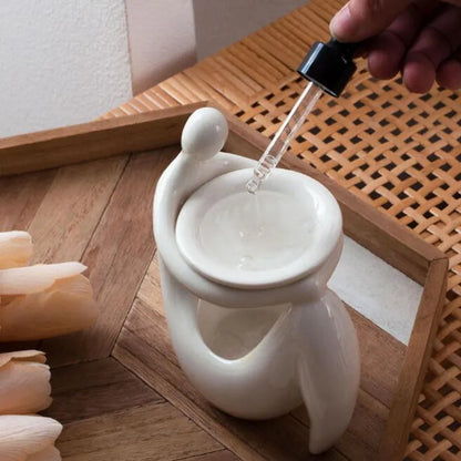 White Porcelain Person Holding Essential Oil Burner